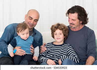 Happy gay men posing sitting on the sofa with their children Gay Men Posing Sitting On Sofa Stockfoto (Jetzt bearbeiten ...