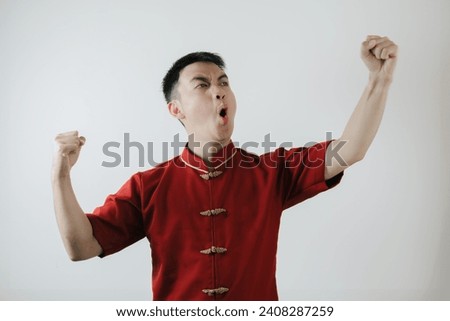 Happy gesture of Asian man wearing Chinese traditional cloth called Cheongsam on white background. Lunar New Year concept.