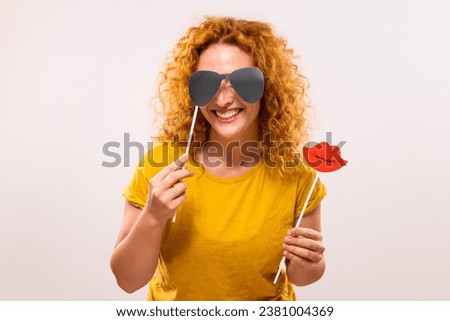 Happy ginger woman is having fun with   party props.