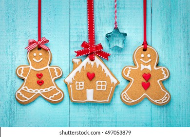 Happy Gingerbread People With House Over A Blue Background.