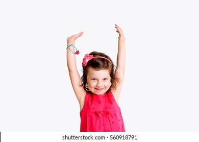 Happy Girl With Arms Up In Front Of White Background