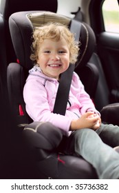 Happy Girl In An Automobile Carseat