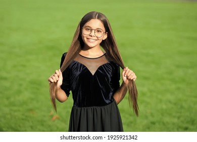 Happy Girl With Beauty Look Smile Holding Long Brunette Hair In Fashion Dress Green Grass Sunny Summer Outdoors, Hairdresser.