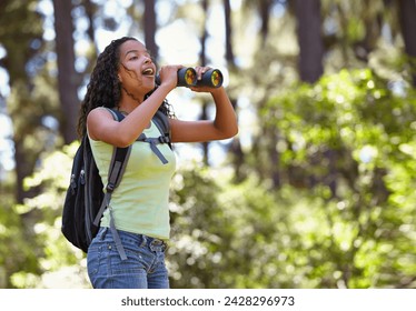 Happy girl, binoculars and nature with backpack for sightseeing, explore or outdoor vision. Young female person, child or teenager enjoying sight, adventure or bird watching and search in forest