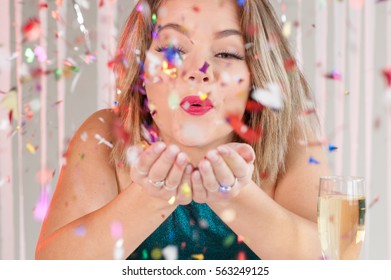 Happy Girl Blowing Colorful Glitter At A Party