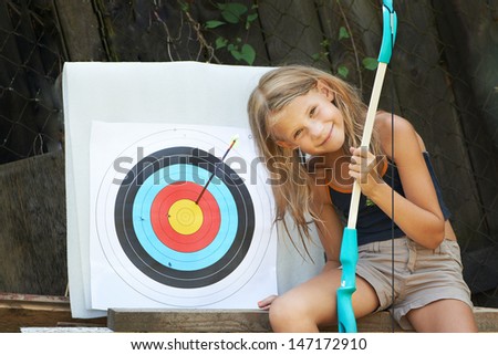 Happy girl with bow and sports aim