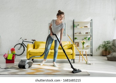 Happy Girl Cleaning Carpet With Vacuum Cleaner