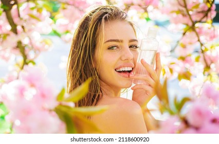 Happy girl with Cleansing water. Natural Cosmetics. Makeup remover. Face tonic. Beauty treatments.