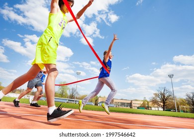 Happy Girl Crossing Finish Line On The Racetrack