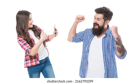 Happy girl daughter show thumbs up and take photo of euphoric man father making winning gesture isolated on white, winner - Shutterstock ID 2162793299
