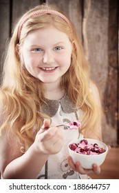 happy girl with dessert on wooden background