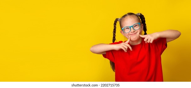 Happy girl with Down syndrome having fun and laughing in the studio. Banner - Shutterstock ID 2202715735