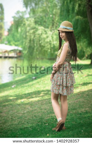 Similar – beautiful young woman smiling while walking in the park