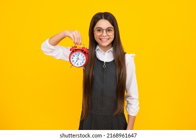 Happy Girl Face, Positive And Smiling Teen Girl Holding Clock Over Yellow Background. Early Morning, Daily Schedule. Child Checking Time. Do Not Be Late. Punctual Kid With Alarm. Deadline Time.