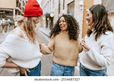 Happy girl friends hanging out in city