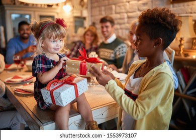  happy girl with  gifts at christmas traditional dinner - Powered by Shutterstock