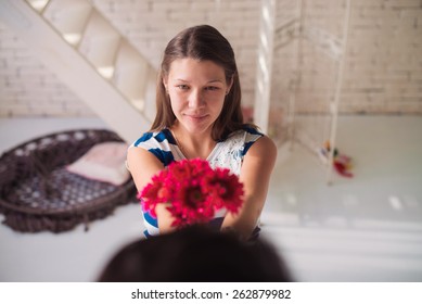 Happy Girl Giving Flowers To Her Husband