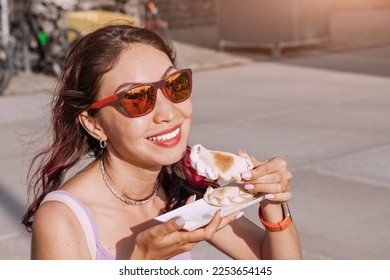 Happy girl has delicious pies with empanadas filling popular in Spain and Argentina. Street food and fast food concept - Shutterstock ID 2253654145