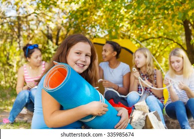 Happy Girl Holding Blue Rolled Spandex Mat