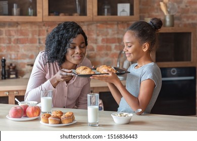 Happy Girl Holding Tray And Smelling Freshly Baked Croissants, Cooking With Mom, Kitchen Interior, Copy Space