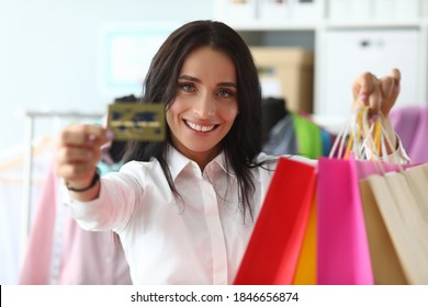 Happy Girl At Home Shows Credit Card And Packages. Make Purchases With Credit Card During Self-isolation. Modern Virtual Shopping. Help From An Independent Stylist. Images Are Composed