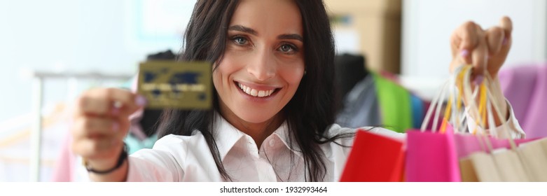 Happy Girl At Home Shows Credit Card And Packages. Make Purchases With Credit Card During Self-isolation. Modern Virtual Shopping. Help From An Independent Stylist. Images Are Composed