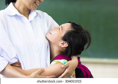 happy  Girl hugging her mother in classroom