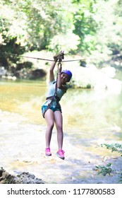 Happy Girl  In-motion On Zipline In Tropical Jungle Rainforest Tree Canopy