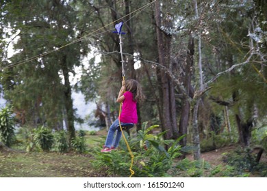 Happy Girl  In-motion On Zipline In Tropical Jungle Rainforest Tree Canopy