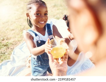 Happy Girl, Juice And Smile In Family Picnic Fun And Joy In Happiness On A Warm Summer Day In Nature. Black Child Smiling For Fresh Cold Healthy Beverage In The Hot Outdoors With Parent And Sibling