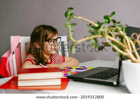 Similar – Image, Stock Photo happy school girl doing homework. Smart child working hard