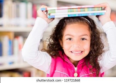 Happy Girl At The Library Holding Books