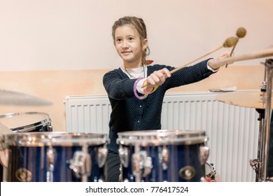 Happy Girl In Music Therapy By Playing Drum Kit On Music Room