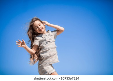 happy girl on blue sky background - Shutterstock ID 1093367324