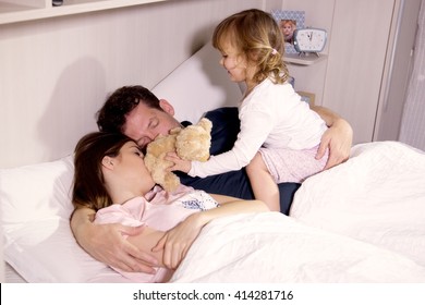 Happy Girl Playing With Teddy Bear Waking Up Parents