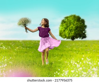 A happy girl runs across the summer field with a bouquet in her hands. There is a huge tree in the background. Girl wearing a pink skirt