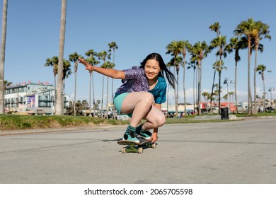 Happy girl skateboarding, fun outdoors sport activity - Powered by Shutterstock