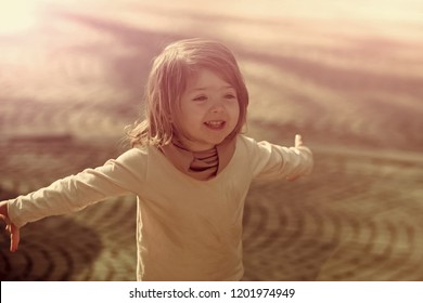 Happy Girl Smile With Open Hand Gesture On Sunny Day On Grey Pavement Outdoor. Child, Innocence, Childhood Concept.