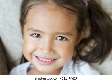 Happy Girl, Smiling Girl, Friendly Girl, Positive Female Kid, Cheerful Girl Looking At You; Close Up Face Portrait Of Happy Positive Smiling Cheerful Preschool Asian Caucasian Preschooler Kid Looking