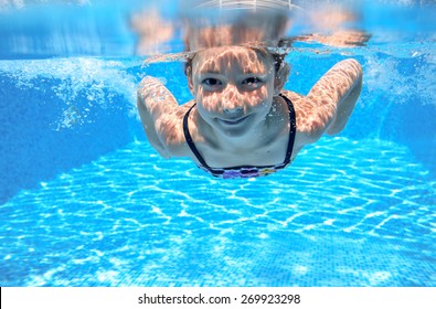 Happy Girl Swims In Pool Underwater, Active Kid Swimming, Playing And Having Fun, Children Water Sport 