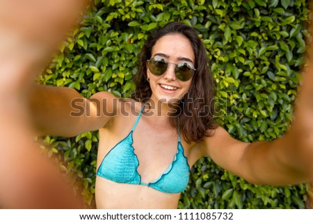 Similar – Brunette surfer woman in bikini standing with surfboard