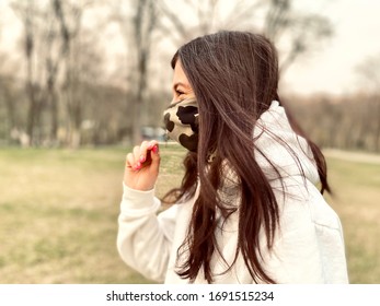 A Happy Girl Taking Off A Protective Mask