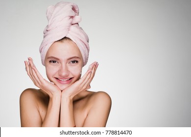 Happy Girl With A Towel On Her Head After Cleaning Her Face Skin