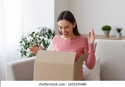 Happy Girl Unboxing Cardboard Box With Present Inside After Buying Ordering Online Via Internet A Present