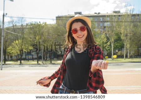 Happy girl walks down the street in spring around the city