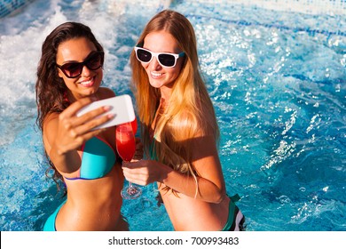 Happy Girlfriend With A Drink On A Summer Party By The Pool Take Selfie On Smartphone