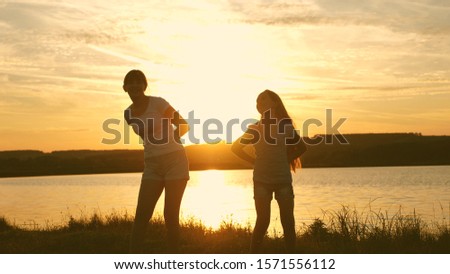 Similar – Schwestern sitzen auf einer Wiese im Sonnenuntergang