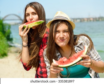 Happy Girls Eating Watermelon On The Beach. Youth Lifestyle. Happiness, Joy, Friendship, Holiday, Beach, Summer Concept. Young People Having Fun Outdoor.