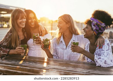 Happy girls having fun drinking cocktails at bar on the beach - Soft focus on center girl face - Powered by Shutterstock