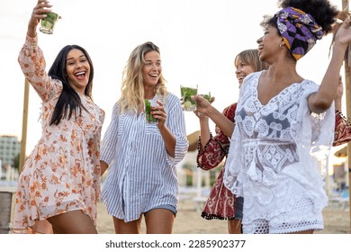 Happy girls having fun drinking alcohol free mojito and dancong on the beach, summer vacation and youth concept, beach party and luxury lifestyle - Powered by Shutterstock